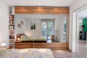 a bedroom with a bed and a glass wall at Ferienwohnung Paffendorf in Gutach