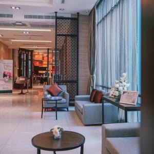 a lobby with couches and tables in a store at Mida Hotel Ngamwongwan - SHA Plus in Nonthaburi