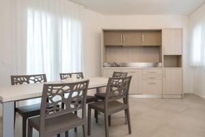 a kitchen and dining room with a table and chairs at Sumus Smart Residence in Porto SantʼElpidio