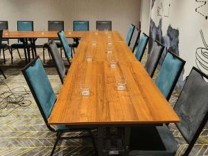a long wooden table with wine glasses on it at ibis styles Bolesławiec in Bolesławiec +111 photos
