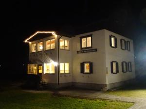 a large white building with lights on it at night at Haus Grünwald in Gosau