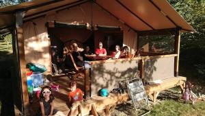 a group of people sitting in a tent at Camping 3 étoiles - ccbfige in Pouancé +4 photos