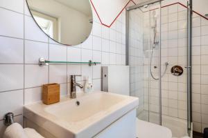 a bathroom with a sink and a shower at Haus Grete in Langenargen +12 photos
