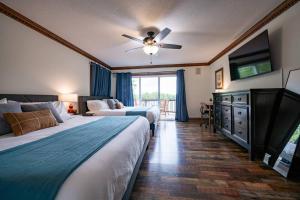 a bedroom with two beds and a ceiling fan at Lakefront Group Stay, Sleeps 19, Indoor Pool, Hot Tub, Arcades in Terre Haute +51 photos