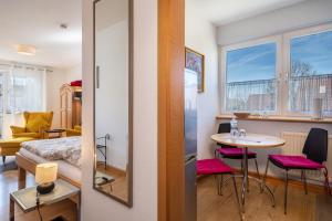 a small room with a bed and a table and chairs at Haus Grete in Langenargen