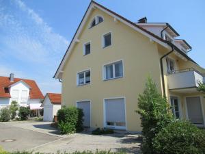 a yellow house with two garage at Haus Grete in Langenargen