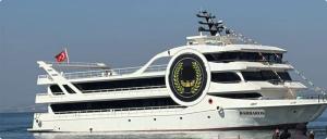 a large white boat sitting in the water at BOSPHOROUS DİNNER CRUISe in Istanbul