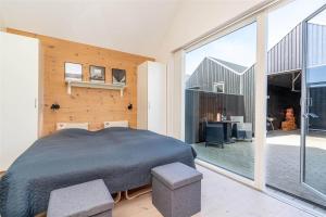 a bedroom with a large bed and a large window at 746-Hvide-Sande-Slusen-46 in Hvide Sande