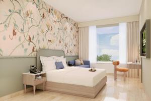 a bedroom with a bed with a flowery wallpaper at Ginger Ekta Nagar, Statue of Unity in Navgam +22 photos
