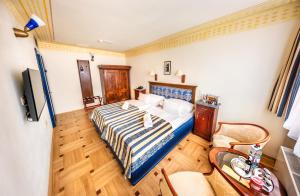 a bedroom with a bed and a television in it at Hotel Elite Prague in Prague