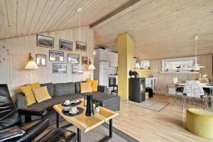 a living room with a couch and a table at 358-Hvide-Sande-Fyrmarken-25 in Hvide Sande