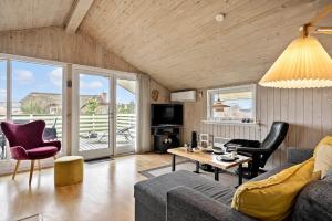 a living room with a couch and a table at 358-Hvide-Sande-Fyrmarken-25 in Hvide Sande