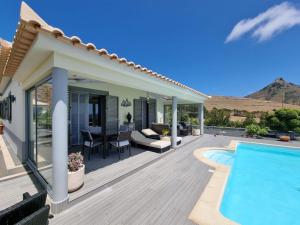 a villa with a swimming pool and a patio at Sol e Luna in Ponta
