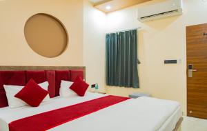 a bedroom with a large white bed with red pillows at Hotel Galaxy 700 - A Luxury Hotel Near KhatuShyamJi Temple in Khātu