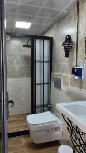 a bathroom with a white toilet and a sink at Hızmalı OTEL in Urfa +20 photos