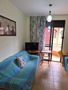 a bedroom with a bed and a table and a chair at Holiday Apartment 70meters from the sea in (( Stan i Ri ))