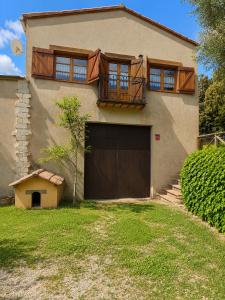 a large house with a garage and a balcony at Winahost Espunyola Berga in L'Espunyola