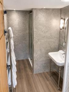 a bathroom with a sink and a mirror and a shower at Lewtrenchard Manor in Lewdown +44 photos
