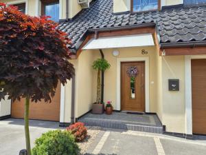 a front door of a house with flowers on it at Lawendowa Home in Milicz
