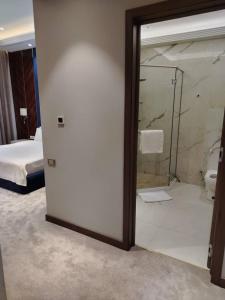 a bathroom with a glass door leading to a bedroom at Chorchaman Hills in Patkunob
