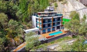 an aerial view of a house with a swimming pool at Chorchaman Hills in Patkunob +6 photos