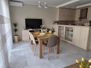 a kitchen with a dining room table and chairs at Lawendowa Home in Milicz