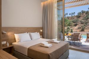 a bedroom with a bed with two towels on it at La Divina Luxury Villas with Heated Pool in Daratso +85 photos