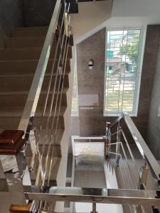 a staircase in a house with a metal railing at Sri Padmavati Pleasants in Palni