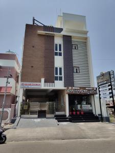 a building with a sign in front of it at Sri Padmavati Pleasants in Palni