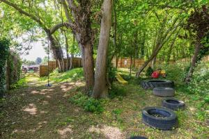 a group of tires on the ground next to a tree at Woods Meadow Glamping in West Malling