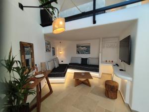 a living room with a couch and a table at Caldera Serenity - Small Luxury Villas in Imerovigli