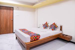 a bedroom with a bed in a room at FabHotel Aarvi Inn in Aurangabad