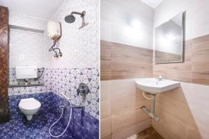 a bathroom with a toilet and a sink at FabHotel Aarvi Inn in Aurangabad