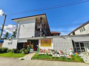 a building with a sign that reads dog house at Ora House in San Kamphaeng