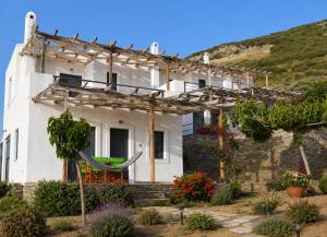 a white house with a pergola at Ravishing View, Zastani Houses in Marmari