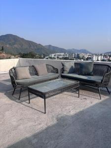 two couches and a coffee table on a patio at Jsrcozystays in Rājpur