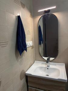 a bathroom with a sink and a mirror at Jsrcozystays in Rājpur +25 photos