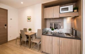 a kitchen and dining room with a table and a microwave at Hotel Luxor Florence in Florence