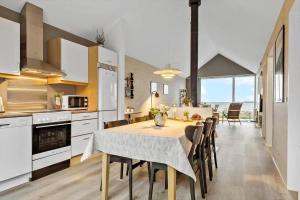 a kitchen and dining room with a table and chairs at 704-Hvide-Sande-Slusen-4 in Hvide Sande