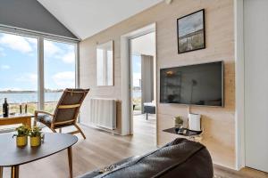 a living room with a large tv and a couch at 704-Hvide-Sande-Slusen-4 in Hvide Sande