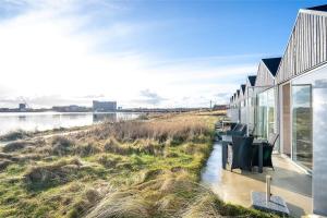 a house on the shore of a body of water at 704-Hvide-Sande-Slusen-4 in Hvide Sande