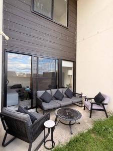 a patio with a couch and chairs and a table at Shared House in Melbourne in Bundoora