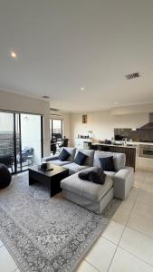 a living room with a couch and a table at Shared House in Melbourne in Bundoora