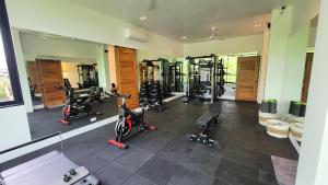 a gym with several treadmills and exercise bikes at Villa Jaliza - Luxury 7 bedroom Villa, Chaweng, Samui in Chaweng Noi Beach
