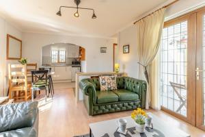 a living room with a green couch and a kitchen at 1 Bed in Bishopston oc-hh654 in Bishopston