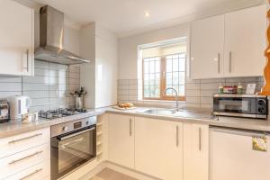 a kitchen with white cabinets and a sink at 1 Bed in Bishopston oc-hh654 in Bishopston +24 photos