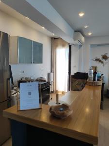 a kitchen and living room with a wooden counter top at Vista mare by Oikies Rentals in Neoi Epivates