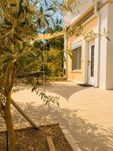 a tree in front of a building with a table at Asana by Agora Flats in Thessaloniki