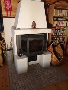 a living room with a fireplace in a house at Talvitahko 3 in Nilsiä