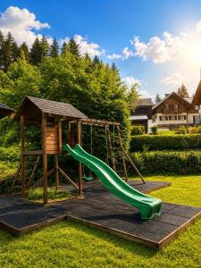 a playground with a slide and a gazebo at Transylvania Villa & Spa in Gosau